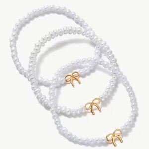 Elegant White Beaded Bracelets with Gold Bow